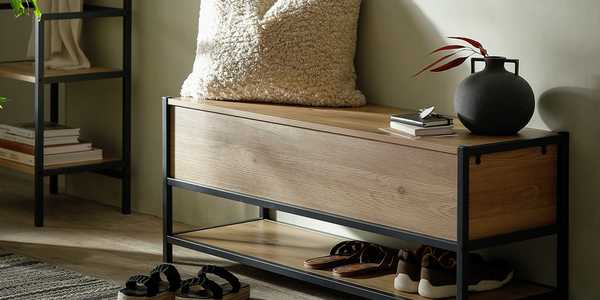 Wooden shoe storage bench with black metal frame.